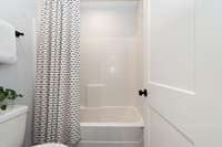 Combination tub/shower and toilet for Jack-and-Jill bath.