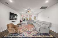 Living room leads to covered back porch