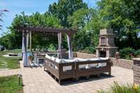 What an outdoor gathering space. Lots of room for outdoor furniture. Trellis area provides shade for a table or a swing bed. Outdoor fireplace brings the perfect ambiance for those chilly nights.