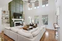 Breathtaking Great Room with hardwood floors, built in shelving, fireplace & look at all these wonderful windows!