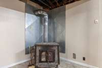 Basement of main home with full bath, kitchen area and 2 car garage with new garage doors. Wood stove remains and has been used as a backup source of heating in the past.