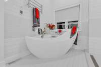 Newly installed free-standing soaking tub with heated floors and towel rack!