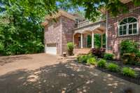 Attached 2 car garage with living quarters, office or music studio above the garage.  Custom windows same as the house.