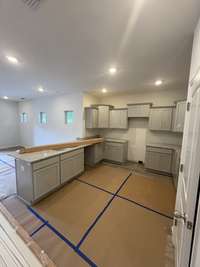 Current status as of 6/23/2025. Kitchen. Will include stainless steel appliances (Refrigerator, Oven, Stove, Dishwasher, and Microwave.