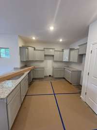 Current status as of 6/23/2025. Kitchen. Will include stainless steel appliances (Refrigerator, Oven, Stove, Dishwasher, and Microwave.