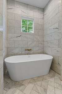 Custom tub area in primary bath with marble accents.