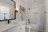 Bathroom with designer tile and custom accents.
