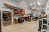 Work shop area in garage with access to more storage.