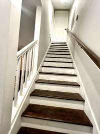 View of the stairs going up to the Utility Room and the Master Bedroom and Bath.