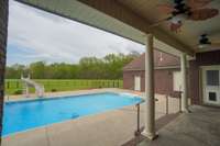 covered patio overlooking the pool and yard