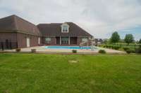 beautiful saltwater pool, the door to the left is the mechanics room for the pool and the other door is a bathroom with access to the pool