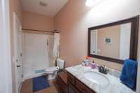 bedroom 3's ensuite bath.  the door to the left leads outside to the pool
