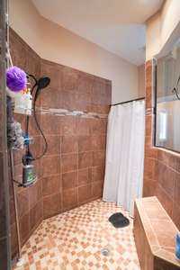 very large shower with a built-in bench
