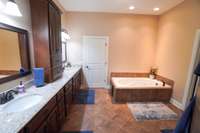primary bath with dual vanities, jetted tub and huge walk-in shower