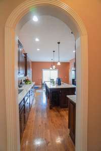 arched entrance to the kitchen from the hallway by the dining room