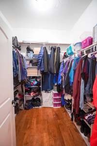 large primary closet located in bathroom