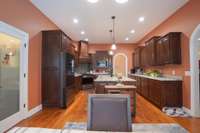 chefs kitchen with custom cabinetry, huge island and large walk-in pantry