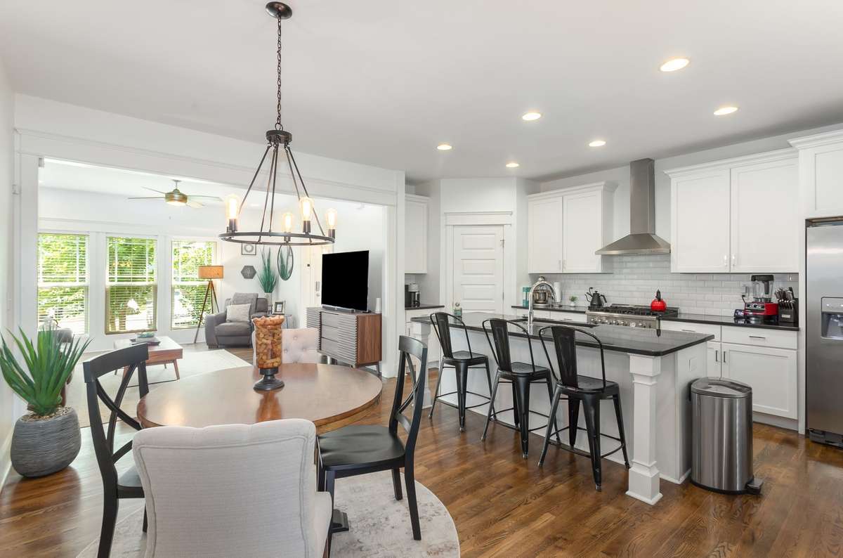 Dining area with statement lighting opening seamlessly to the kitchen and living spaces for effortless everyday living and entertaining.