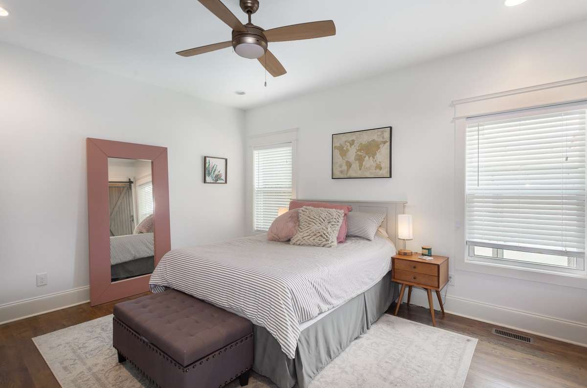 The primary suite is located on the first floor, with hardwood floors continuing throughout.