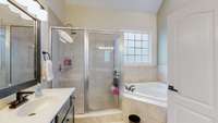 2 separate vanities, tiled shower and soaking tub