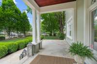 Just beyond the gated entrance is a welcoming covered, front porch
