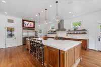 An antique door leads to a pantry. The kitchen is well equipped with top of the appliances as well