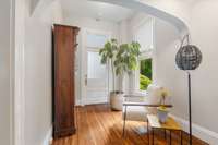 A lovely alcove leads to a porch entry