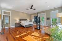 An absolutely huge primary suite with amazing windows and french doors leading to the upstairs covered balcony