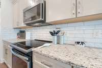 Beautiful granite, backsplash, custom cabinetry and thoughtful lighting makes this kitchen sparkly.
