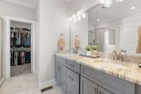 Primary bathroom with extra large walk-in closet and leather granite vanity.