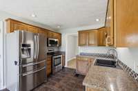 Another view of the kitchen. Notice the can lights and great refrigerator.