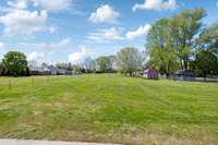 Another view of the backyard, which includes a storage building.