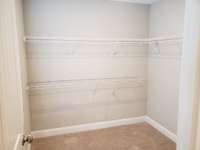 2nd walk-in closet in the primary, accessed via the door between the vanities.