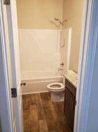 Bathroom located off the living room, next to the main level bedroom.