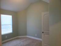 Bedroom 2 right next to the steps and bathroom, notice the vaulted ceiling.