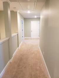 Upstairs hallway looking toward the laundry room, bonus room is the doors on the left, Primary is to the right of the laundry.