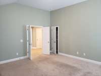 Bonus room looking toward the doors and the small closet! Could make for a very generously sized bedroom.
