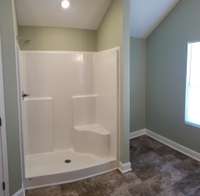 Primary bath shower with extra space next to the shower.
