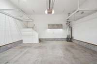 Grand working garage with lighted cabinets hanging storage rails