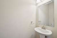 Powder room by garage and Laundry Room - private hallway
