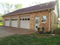 3 car garage with full loft storage, half bath, insulated, gas heat & windows A/C