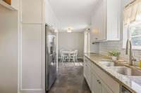 Adorable, updated kitchen with plenty of natural light—bright, stylish, and ready for your favorite meal prep.