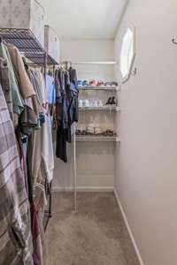 The primary bedroom features a spacious walk-in closet, offering plenty of room for your wardrobe and accessories.