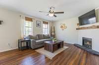 The living room is filled with natural light, creating a bright and inviting atmosphere.