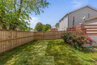 The backyard features a less-than-2-year-old fence, offering privacy and security with a like-new look.