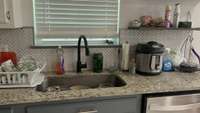 Granite Countertops and Tile backsplash in herringbone pattern.