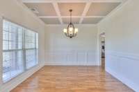 Shows the gleaming oak floors and wainscotting