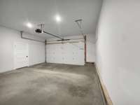 Expansive 600 sq ft garage with oversized closet perfect for hobbyist or car enthusiast