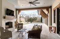 This covered porch with a wood burning fireplace is like an additional living room as the French doors from the kitchen/great room open right onto this space.