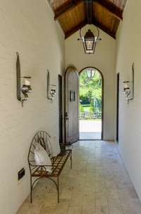 This auxiliary side entrance and breezeway connects the main house to the separate space over the garage which is currently the owners office retreat.